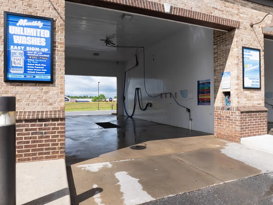 Inside a self-serve wash bay with high pressure wand at Woodstock Car Wash