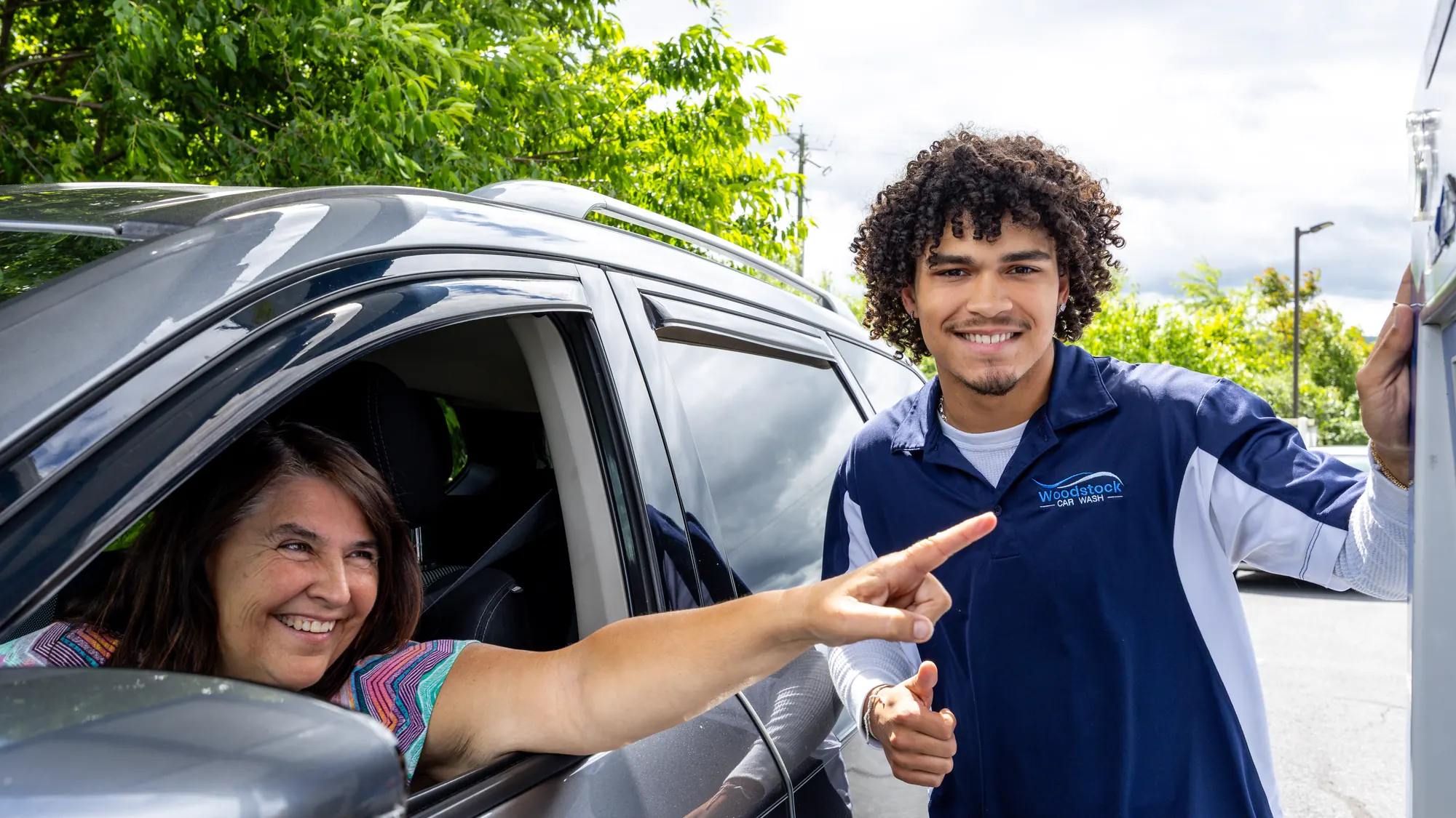 Woodstock Car Wash team member with a customer at the wash entrance