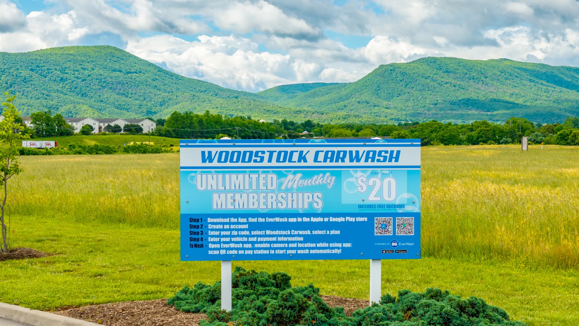 Woodstock Car Wash roadside sign advertising unlimited monthly memberships starting at $20