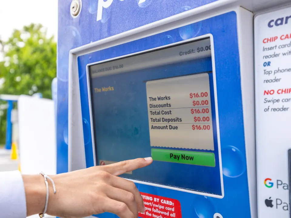 Customer paying for a car wash at the Woodstock Car Wash pay station