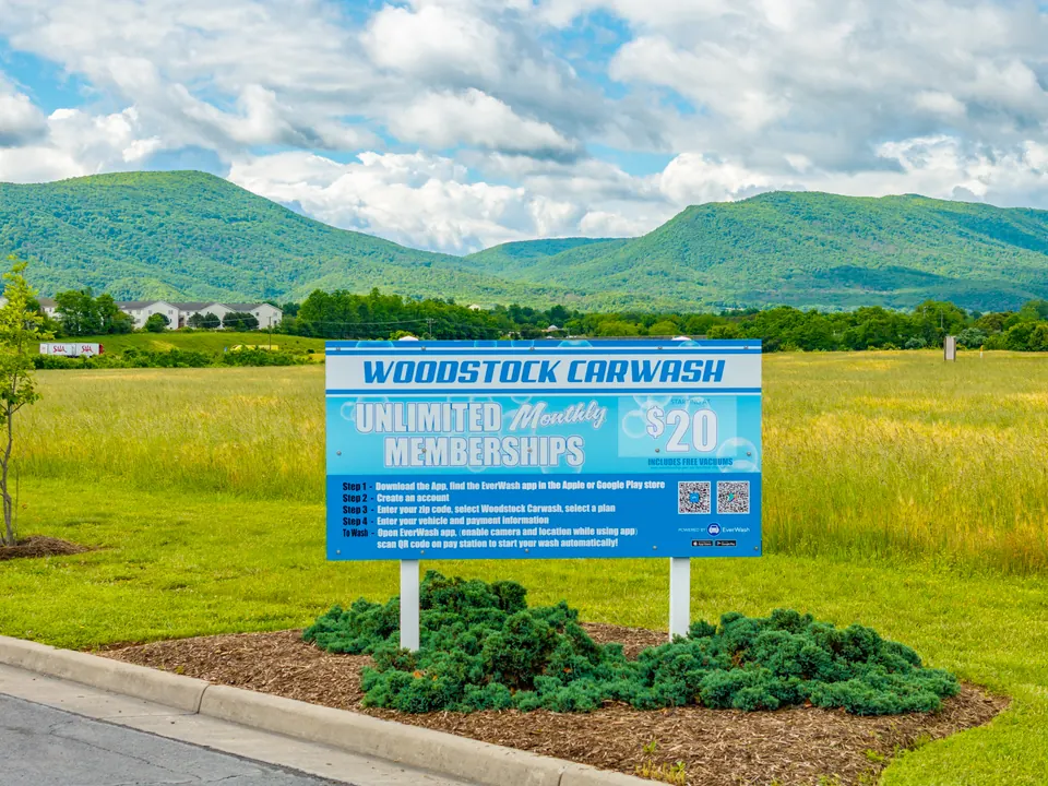 Woodstock Car Wash roadside sign with unlimited monthly memberships from $20